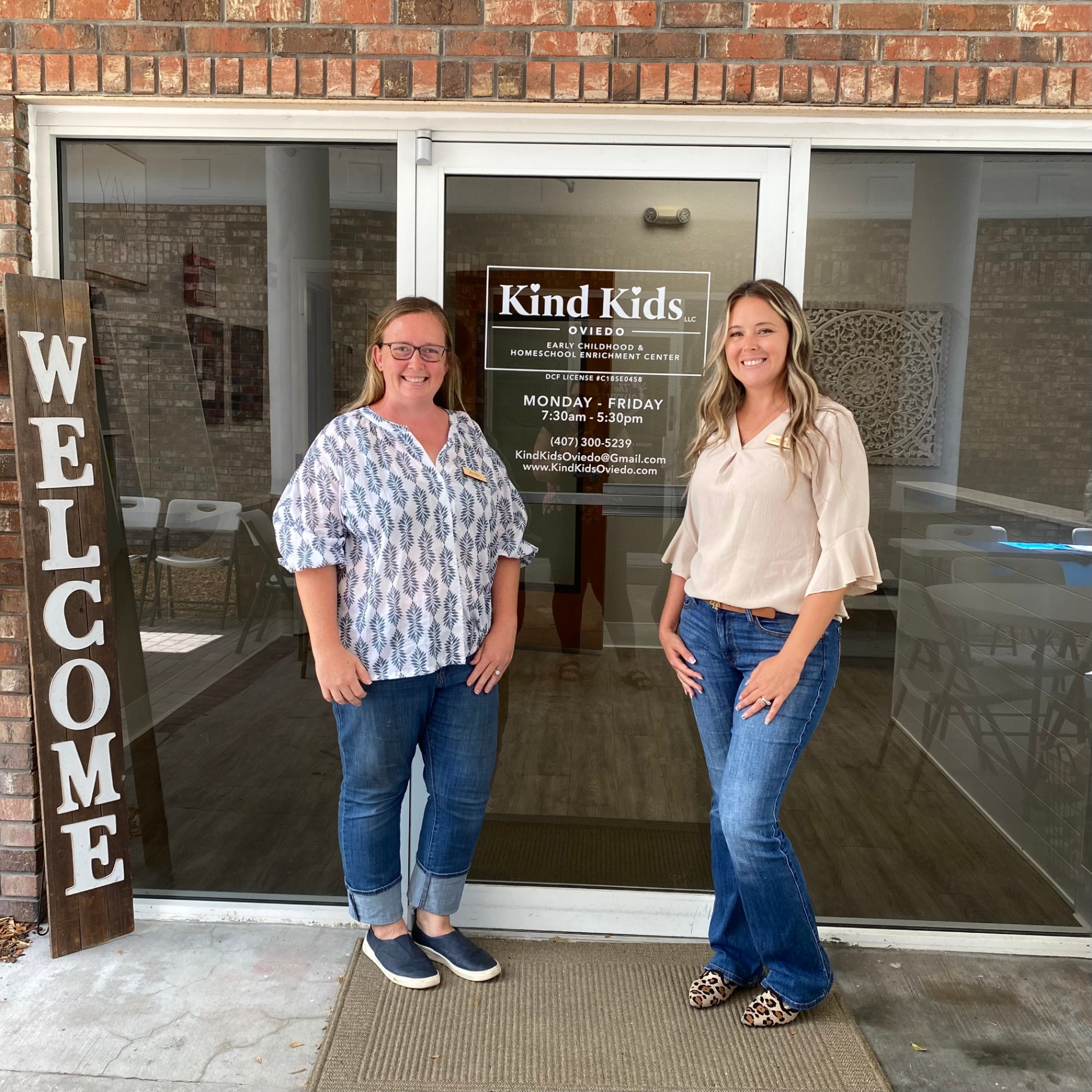 Jennifer and Sabrina, Kind Kids founders, standing at the entrance of the Kind Kids Oviedo center